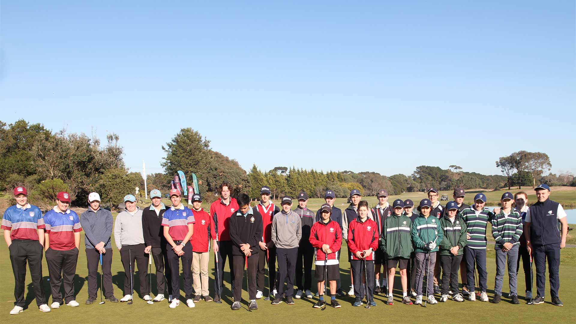 Geelong Independent School Sports Association golf members positioned on a well-manicured golf course, engaged in a social gathering.