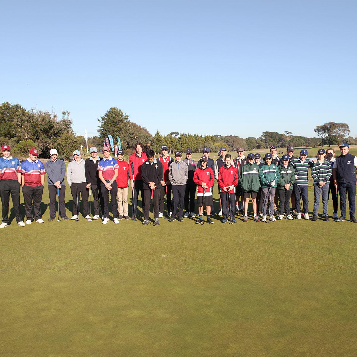 Geelong Independent School Sports Association golf members positioned on a well-manicured golf course, engaged in a social gathering